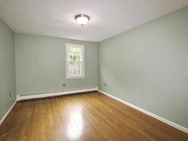 14 Oak Cir, Princeton, MA 01541 - empty room featuring a baseboard heating unit and wood finished floors