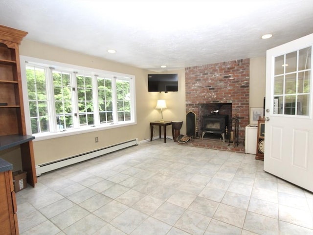 14 Oak Cir, Princeton, MA 01541 - unfurnished living room featuring baseboard heating, a wood stove, light tile patterned floors, and recessed lighting