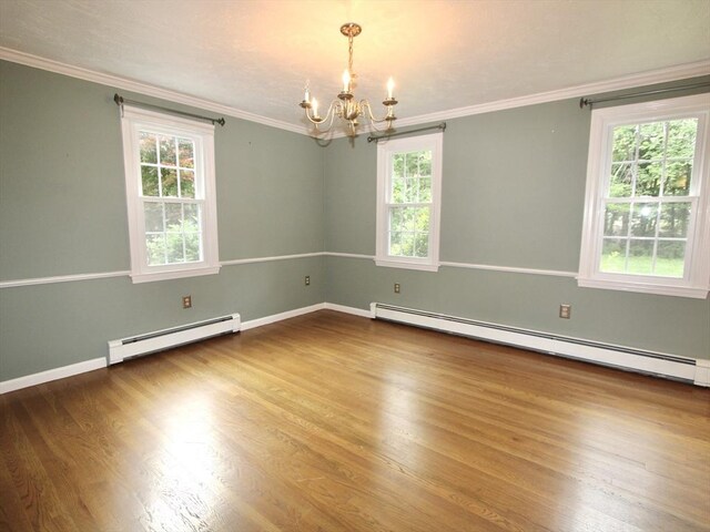14 Oak Cir, Princeton, MA 01541 - empty room with a baseboard heating unit, a chandelier, ornamental molding, and wood finished floors