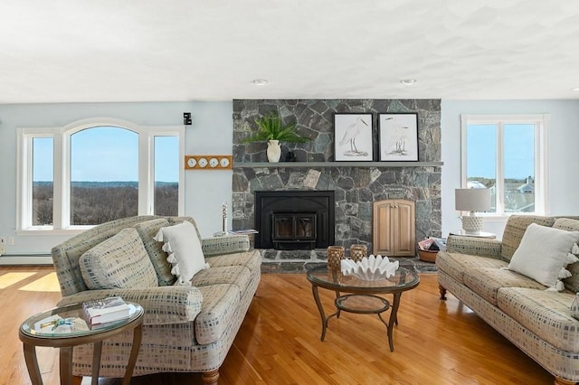 3 Longview Ter, Gloucester, MA 01930 - living room featuring plenty of natural light, baseboard heating, a fireplace, and wood finished floors