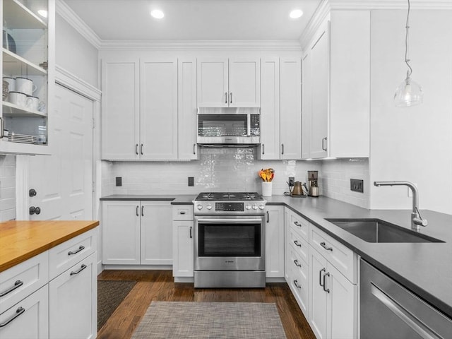 9 Sedgwick St Unit 1, Boston, MA 02130 - kitchen featuring stainless steel appliances, white cabinets, dark wood finished floors, glass insert cabinets, and recessed lighting