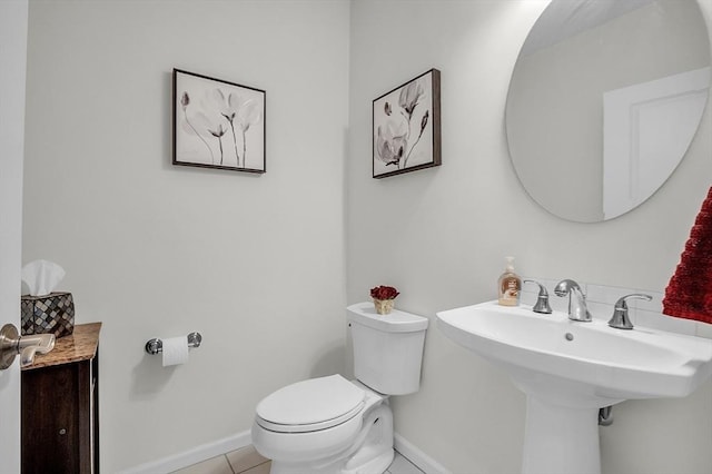 bathroom featuring tile patterned floors, sink, and toilet