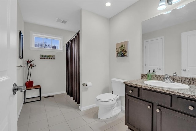 bathroom with vanity, tile patterned flooring, and toilet