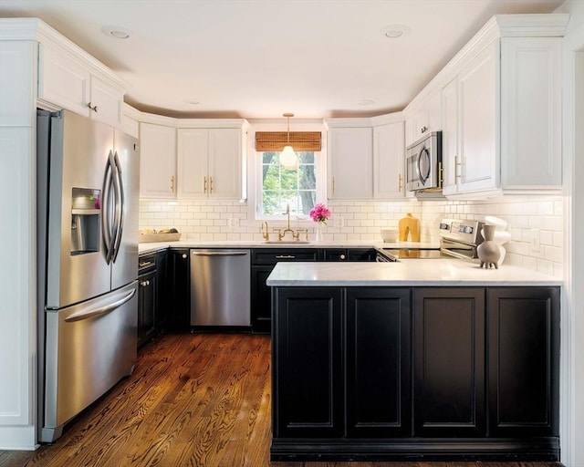 16 Hart Pl, Woburn, MA 01801 - kitchen with stainless steel appliances, a peninsula, light countertops, and white cabinetry