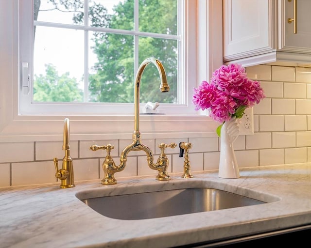16 Hart Pl, Woburn, MA 01801 - kitchen view of light stone countertops, decorative backsplash, and white cabinets