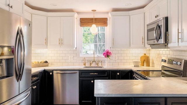 16 Hart Pl, Woburn, MA 01801 - kitchen with appliances with stainless steel finishes, dark cabinetry, white cabinetry, and light countertops