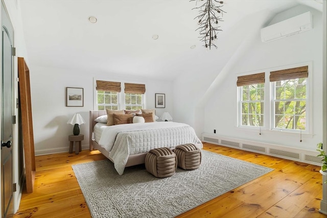 16 Hart Pl, Woburn, MA 01801 - bedroom with a wall mounted AC, vaulted ceiling, light wood-type flooring, and radiator heating unit