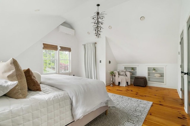 16 Hart Pl, Woburn, MA 01801 - bedroom with a wall unit AC, wood finished floors, and vaulted ceiling