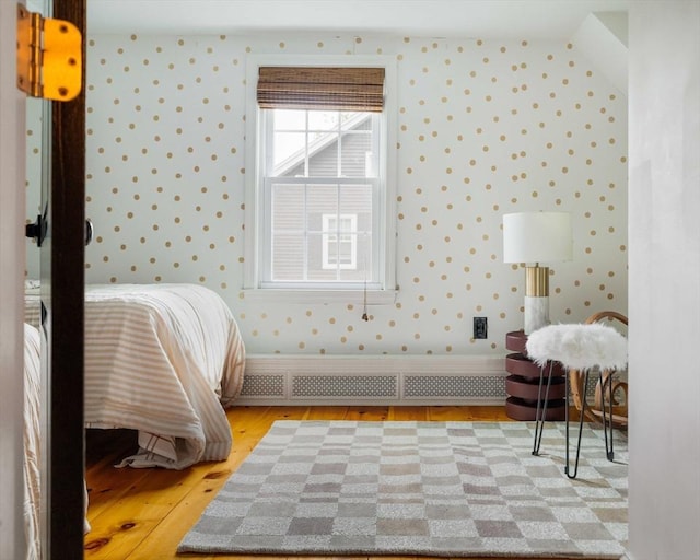 16 Hart Pl, Woburn, MA 01801 - bedroom featuring wallpapered walls, radiator, and light wood-style flooring