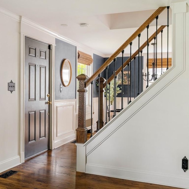 16 Hart Pl, Woburn, MA 01801 - foyer with crown molding, wood finished floors, stairway, a wainscoted wall, and a decorative wall