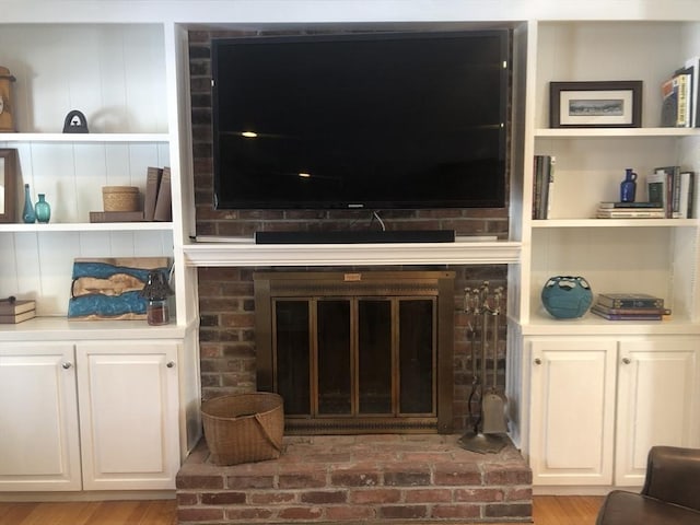 living area with a fireplace and light wood-style flooring