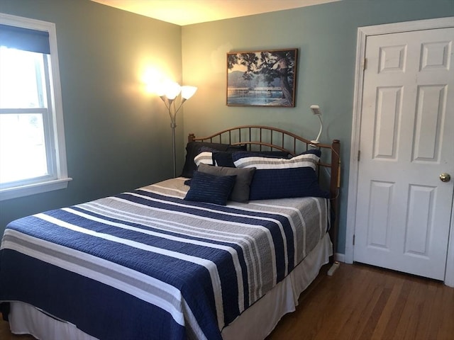 bedroom with dark wood-style floors