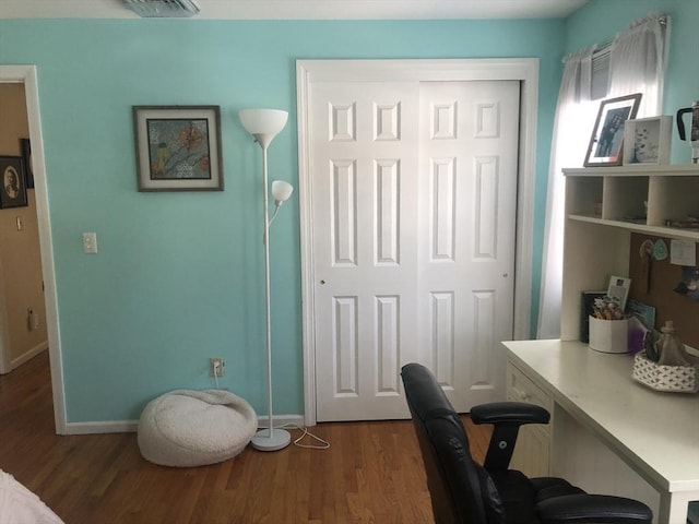 office area with dark wood-style floors and baseboards