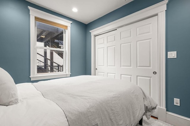bedroom with a closet and baseboards