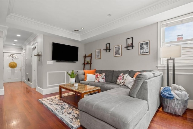 living area with wood finished floors, crown molding, baseboards, and recessed lighting