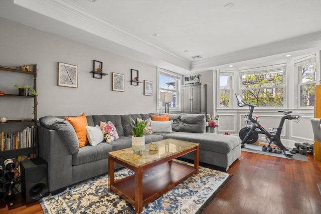 living room with ornamental molding, a tray ceiling, hardwood / wood-style floors, and recessed lighting