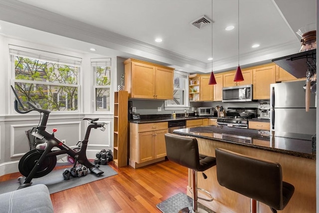kitchen featuring appliances with stainless steel finishes, ornamental molding, open shelves, light wood finished floors, and hanging light fixtures