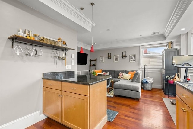 kitchen with dark wood-style floors, open floor plan, open shelves, crown molding, and dark stone counters