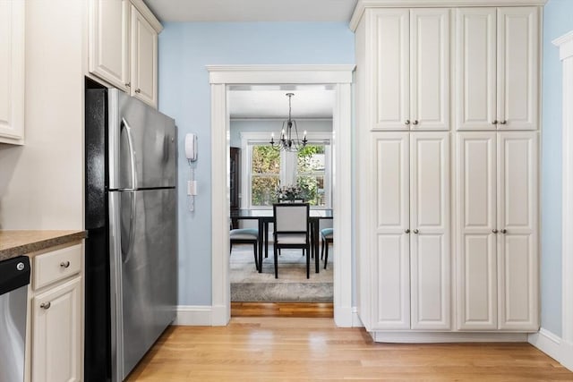 33 Lowell Ave, Watertown, MA 02472 - kitchen featuring appliances with stainless steel finishes, a chandelier, baseboards, and light wood finished floors