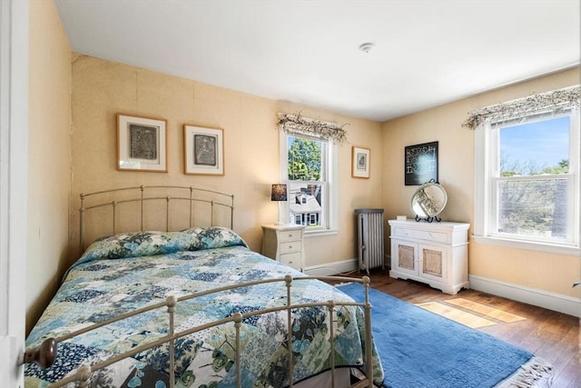 33 Lowell Ave, Watertown, MA 02472 - bedroom with radiator, wood finished floors, and baseboards