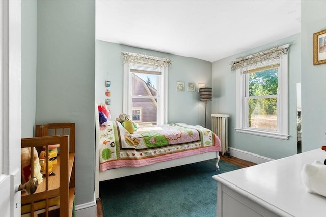 33 Lowell Ave, Watertown, MA 02472 - bedroom featuring radiator heating unit, multiple windows, baseboards, and dark wood-style floors