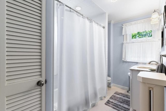 33 Lowell Ave, Watertown, MA 02472 - bathroom with toilet, baseboards, vanity, crown molding, and shower / tub combo with curtain
