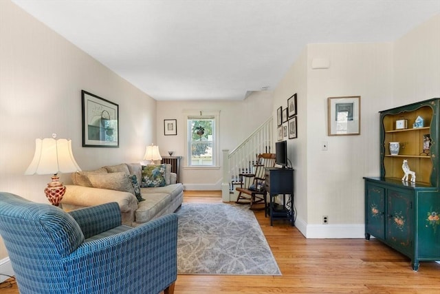 33 Lowell Ave, Watertown, MA 02472 - living room featuring light wood finished floors, baseboards, and stairway