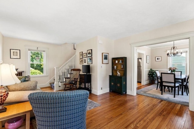 33 Lowell Ave, Watertown, MA 02472 - living room featuring wood-type flooring, a chandelier, stairway, and baseboards