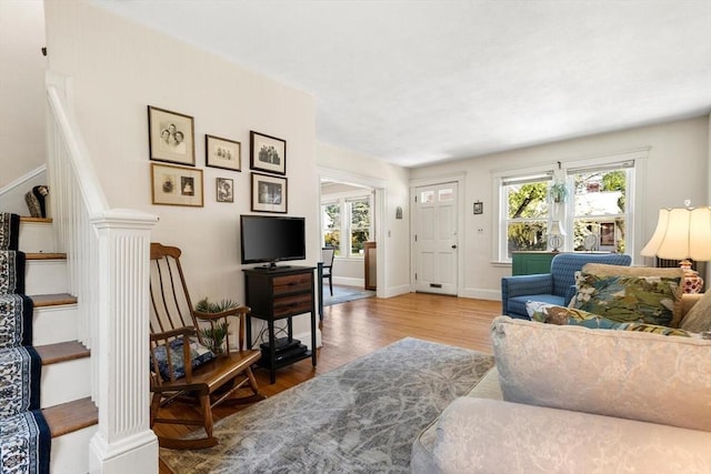 33 Lowell Ave, Watertown, MA 02472 - living area featuring plenty of natural light, wood finished floors, stairs, and baseboards