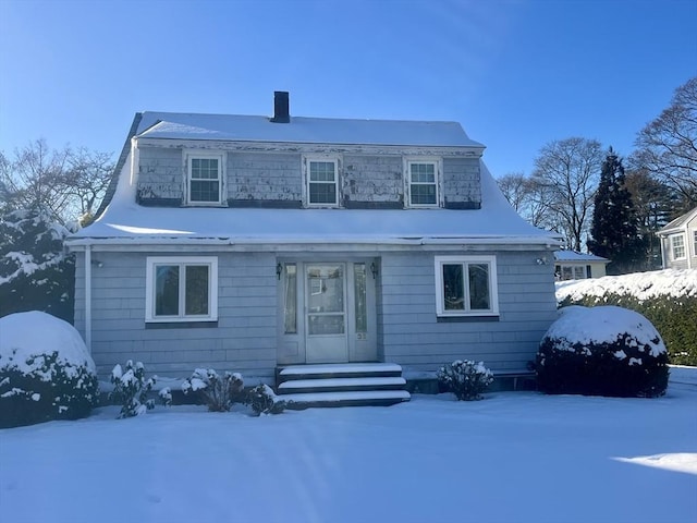 view of snow covered rear of property