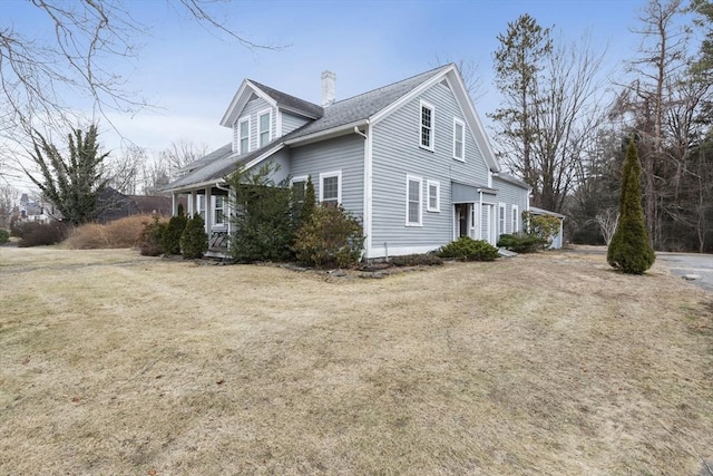 view of side of property with a yard