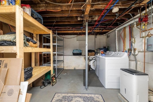 unfinished basement featuring separate washer and dryer