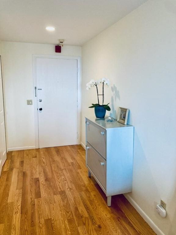 entryway with light wood-style flooring and baseboards