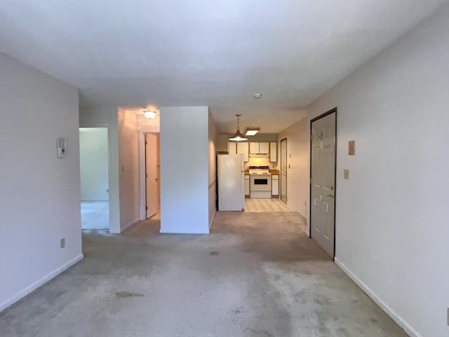 3 Bridgeview Cir Unit 55, Tyngsborough, MA 01879 - unfurnished living room featuring baseboards