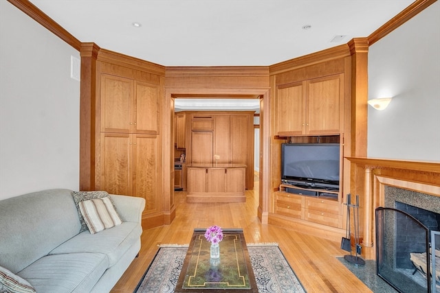 living room with crown molding and light hardwood / wood-style flooring