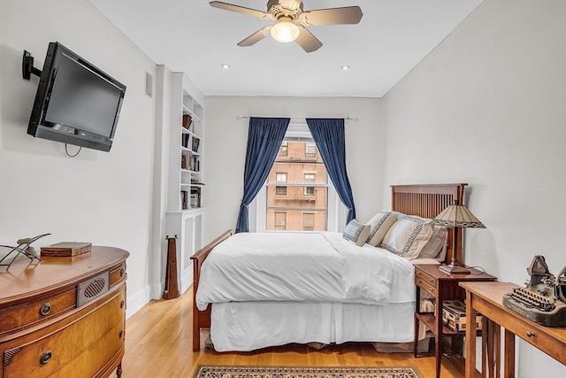 bedroom with light wood-type flooring and ceiling fan