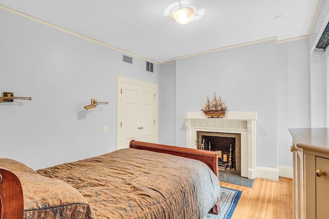 bedroom featuring light hardwood / wood-style flooring and ornamental molding