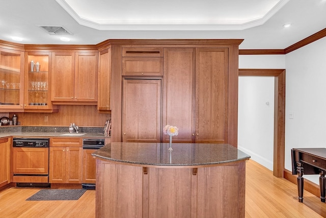 kitchen with dishwashing machine, light hardwood / wood-style floors, sink, dark stone counters, and ornamental molding