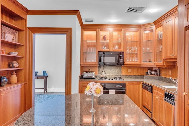 kitchen featuring ornamental molding, black appliances, sink, and light stone countertops