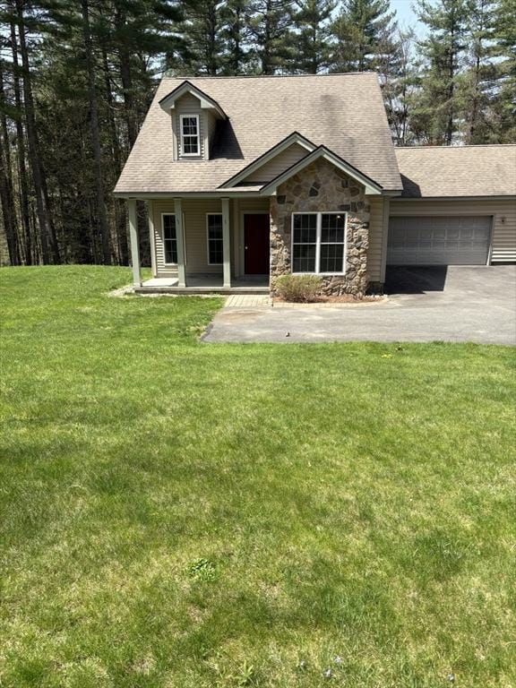 view of front of home featuring a shingled roof, an attached garage, stone siding, aphalt driveway, and covered porch