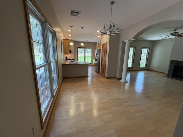 interior space with a ceiling fan, visible vents, arched walkways, ornate columns, and recessed lighting