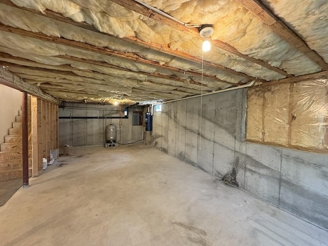 unfinished basement featuring stairs