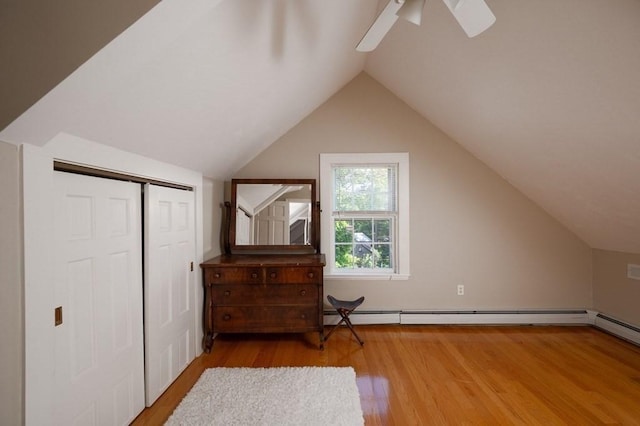 bonus room featuring ceiling fan, baseboard heating, lofted ceiling, and hardwood / wood-style flooring