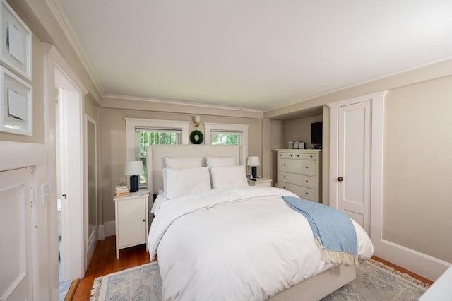 bedroom featuring ornamental molding and dark hardwood / wood-style floors