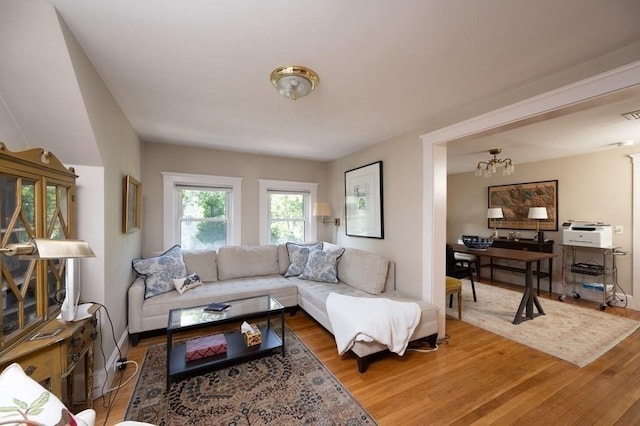 living room with a chandelier and hardwood / wood-style flooring