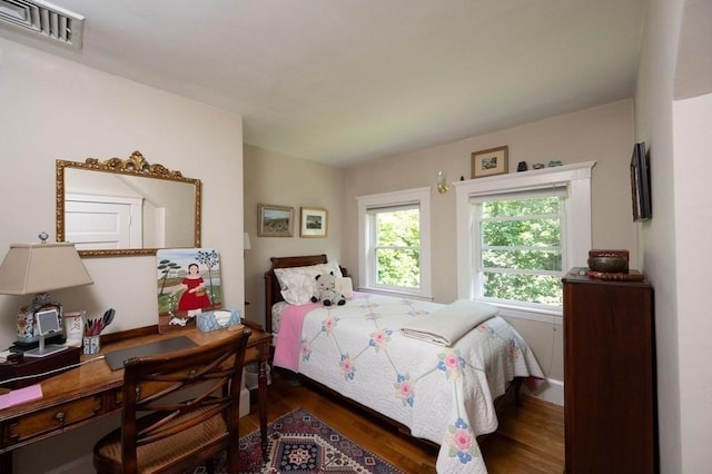 bedroom with dark hardwood / wood-style floors