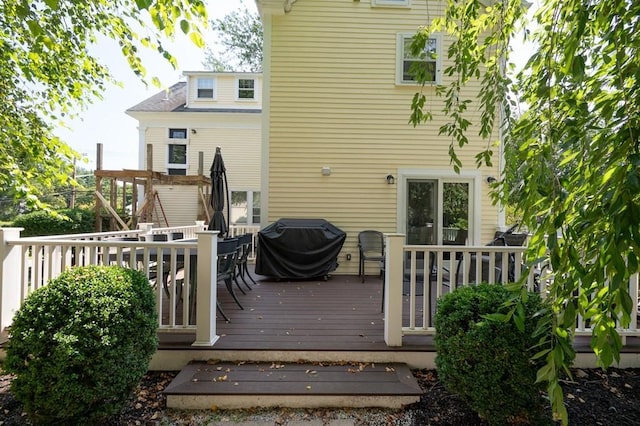 wooden terrace featuring a grill