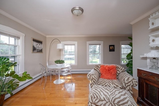 living room with baseboard heating, light wood-type flooring, and crown molding