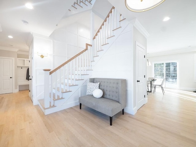 7 Brookdale Rd, Natick, MA 01760 - stairs featuring crown molding, a decorative wall, recessed lighting, and wood finished floors