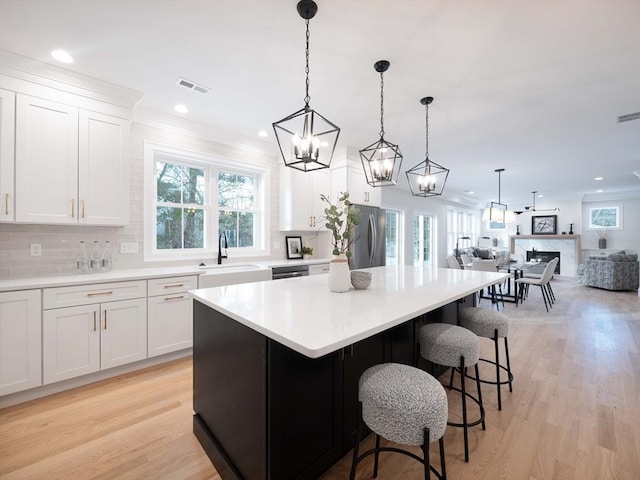 7 Brookdale Rd, Natick, MA 01760 - kitchen featuring stainless steel appliances, open floor plan, visible vents, and tasteful backsplash
